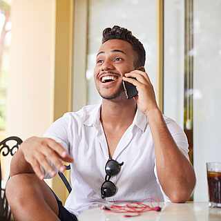 Man sitting at a table with a telephone